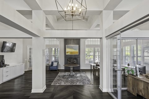 A large, open living room with a high ceiling and a chandelier.