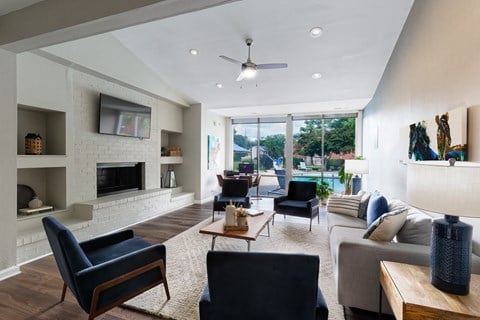 a living room with a white brick fireplace and a couch and chairs