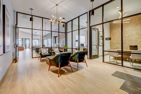 a living room with glass walls and a table and chairs