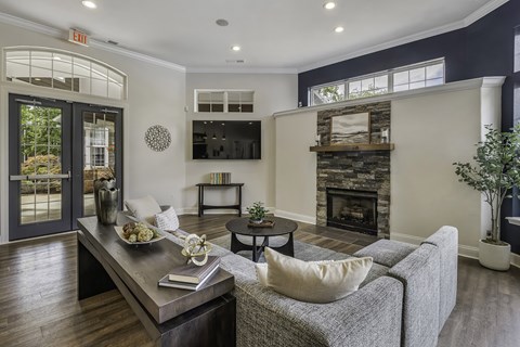 A living room with a grey couch and a wooden coffee table.