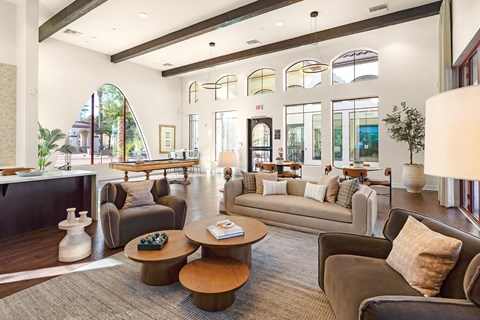 A living room with a brown couch and a coffee table.