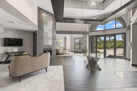 A modern living room with a large couch and a fireplace.