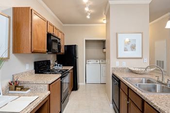 Cordillera Ranch Apartments - Chef kitchen with black Whirlpool appliances