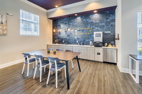 a dining room with a table and chairs and a kitchen