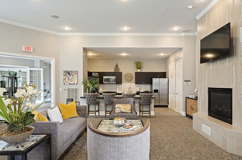 a living room with a couch and a table with a fireplace