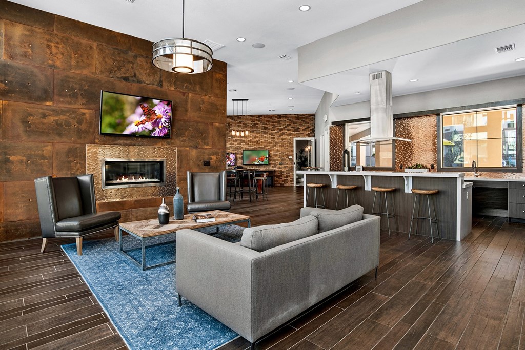 First and Main Apartments clubhouse fireplace lounge area and kitchen breakfast bar