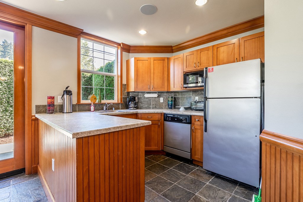 Kitchen with stainless steel appliances - Springbrook Apartments
