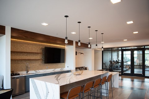 a large kitchen with a marble counter top and stainless steel appliances
