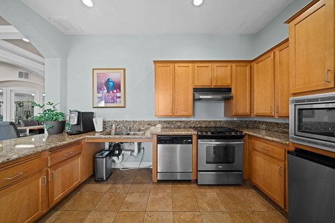 the kitchen has granite counter tops and stainless steel appliances