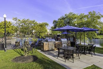 The Gardens at Polaris grilling station area with picnic tables and seating