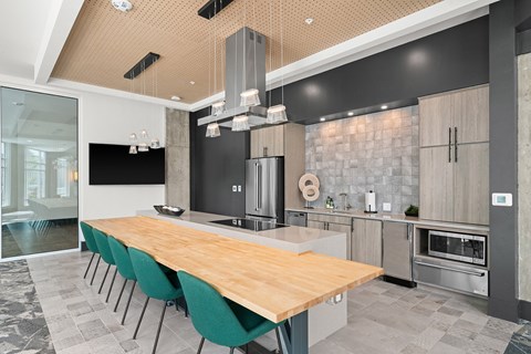 a large kitchen with a wooden table and chairs