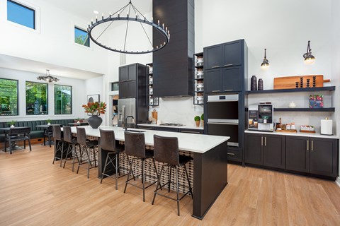 a kitchen with a large island and a table with chairs