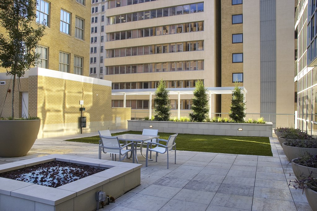 a courtyard with tables and chairs and a fountain