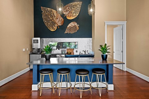 a kitchen with a blue counter top and stools
