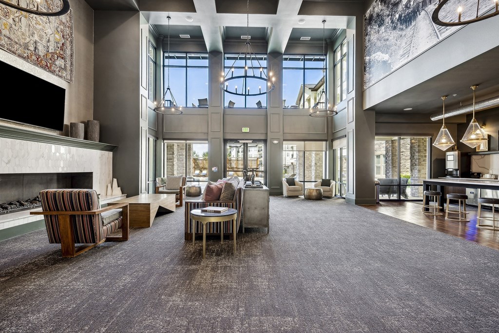 a large living room with a fireplace and large windows