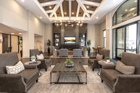 A large, modern living room with brown couches and a coffee table.