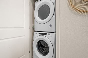 a front load washer and dryer in a laundry room
