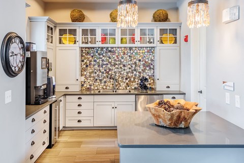 a kitchen with white cabinets and a counter top