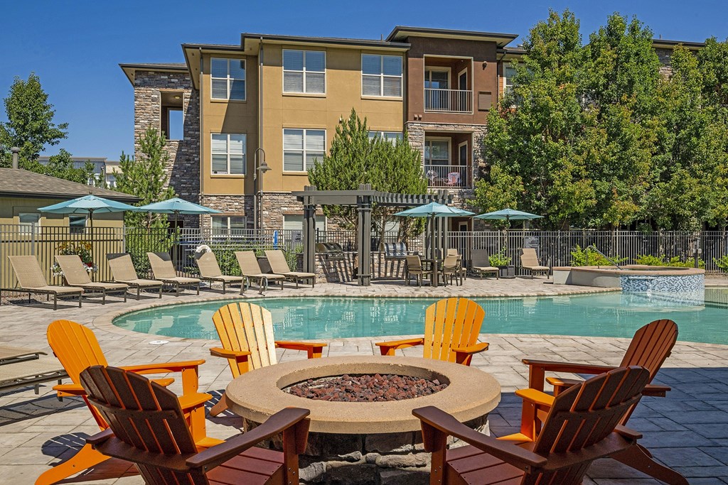 Poolside fire pit with lounge seating - Acadia at Cornerstar Apartments