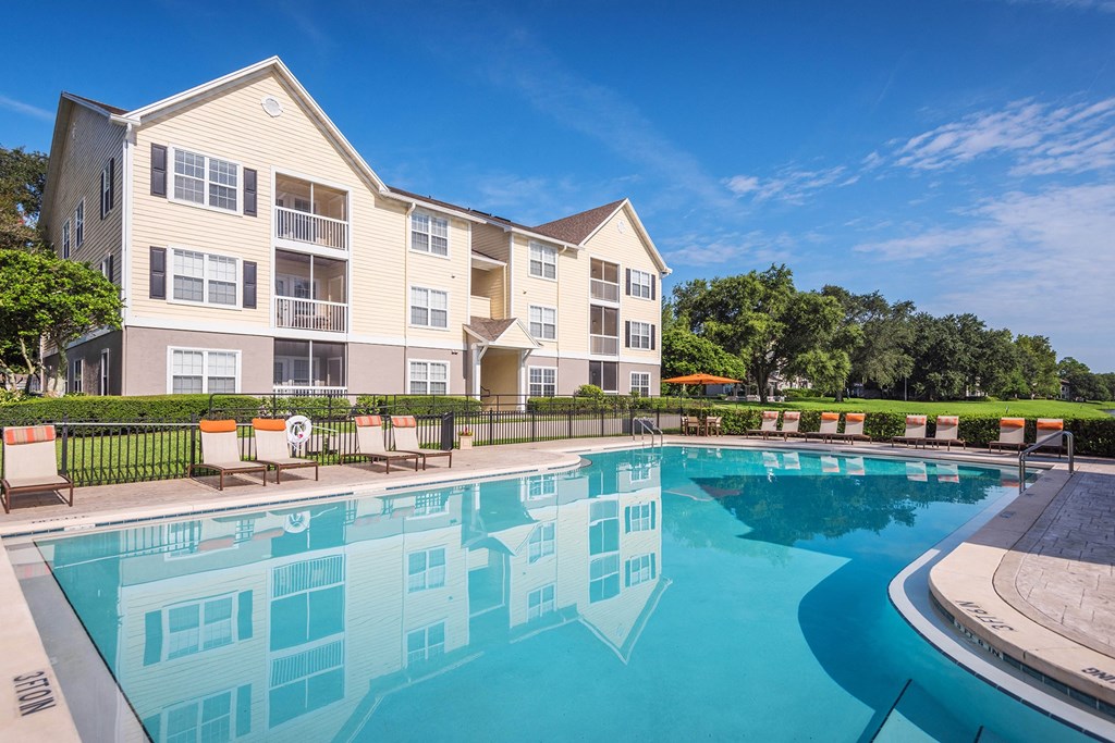 The Colony at Deerwood Apartments - Resort-style swimming pool with lounge area