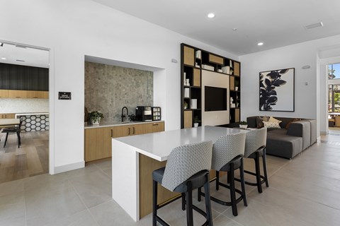 A modern kitchen with a dining table and chairs.