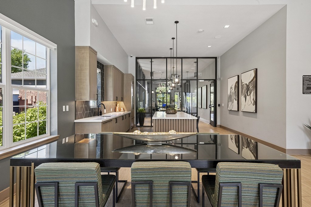 A modern kitchen with a glass table and chairs.