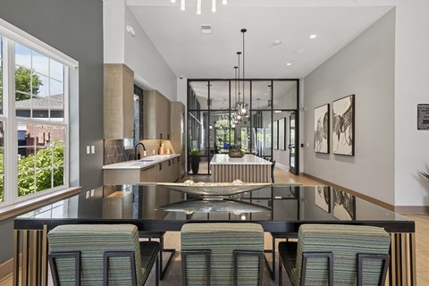 A modern kitchen with a glass table and chairs.