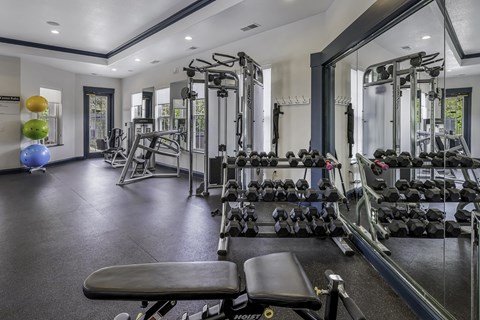 Fully-equipped fitness center with weights - Lantern Woods Apartments
