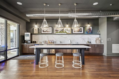a kitchen with a table and stools