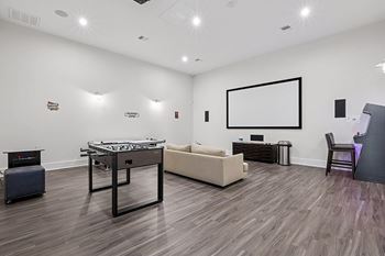 Theater room with foosball and arcade games - First and Main Apartments