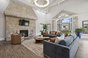 Resident clubhouse with lounge and fireplace - Grand Centennial Apartments