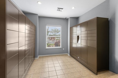 A room with a window and a wall of lockers.