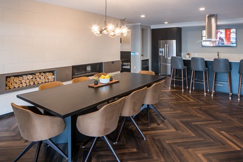 a dining room and kitchen with a long table and chairs