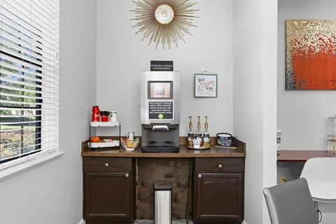 A kitchen with a counter and a fridge.