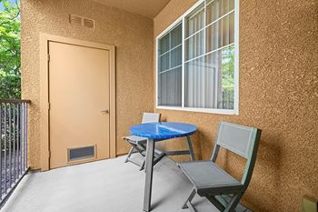a patio with a table and two chairs