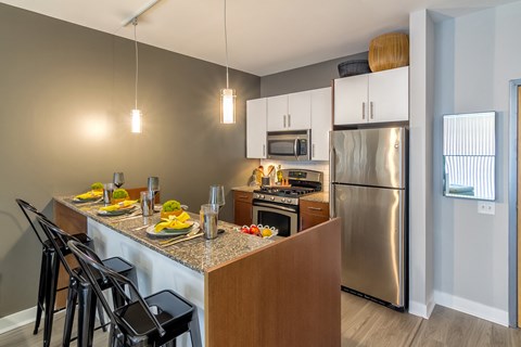 kitchen with stainless steel appliances and granite counter tops at the flats at obsidian