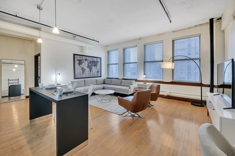 A modern living room with a black and white color scheme.