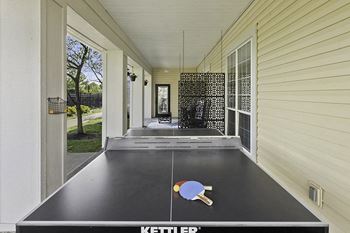 Patio with ping pong table and lounge area - The Gardens at Polaris