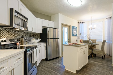 a kitchen with stainless steel appliances and white cabinets