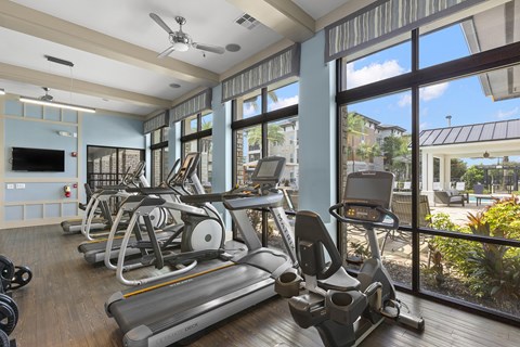 24-hour fitness center with cardio equipment - Nona Park Village Apartments