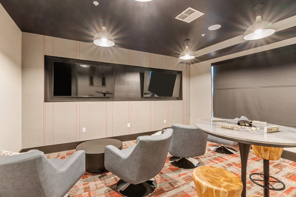 Arazo clubhouse interior with lounge chairs and high tables