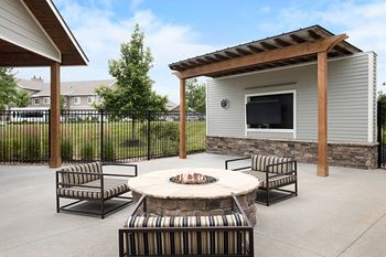 Outdoor TV lounge with cozy fire pit