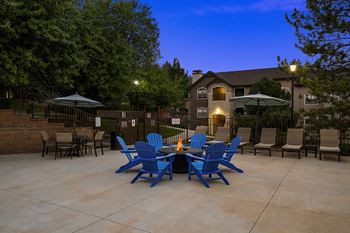 Outdoor fire pit with seating - Grand Centennial Apartments