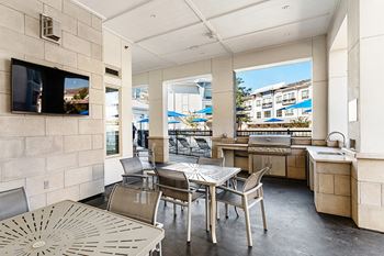BBQ grills and outdoor seating area with nearby fire pit - Everlee