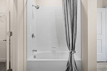 a bathroom with a bathtub and shower