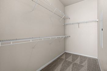 Spacious walk-in closets with custom designed wire shelving