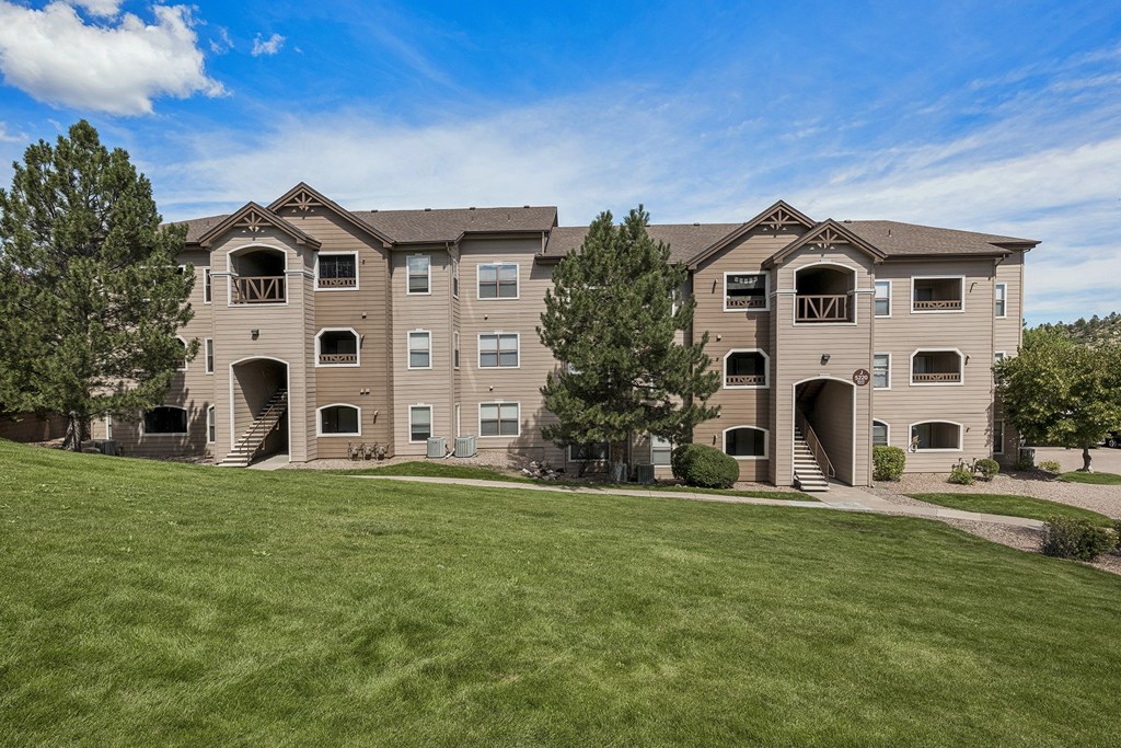 Manicured landscaping through the property - Grand Centennial Apartments