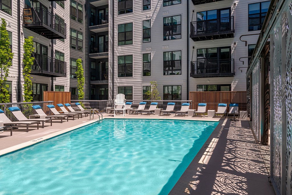 Swimming pool with lounge chairs - Rockwell at Crown