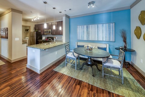 a dining room and kitchen with a table and chairs