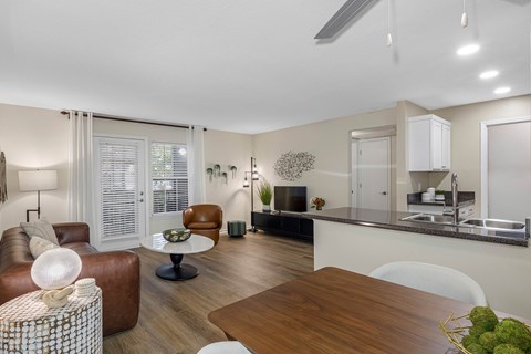 A modern living room with a brown leather sofa and a wooden coffee table.